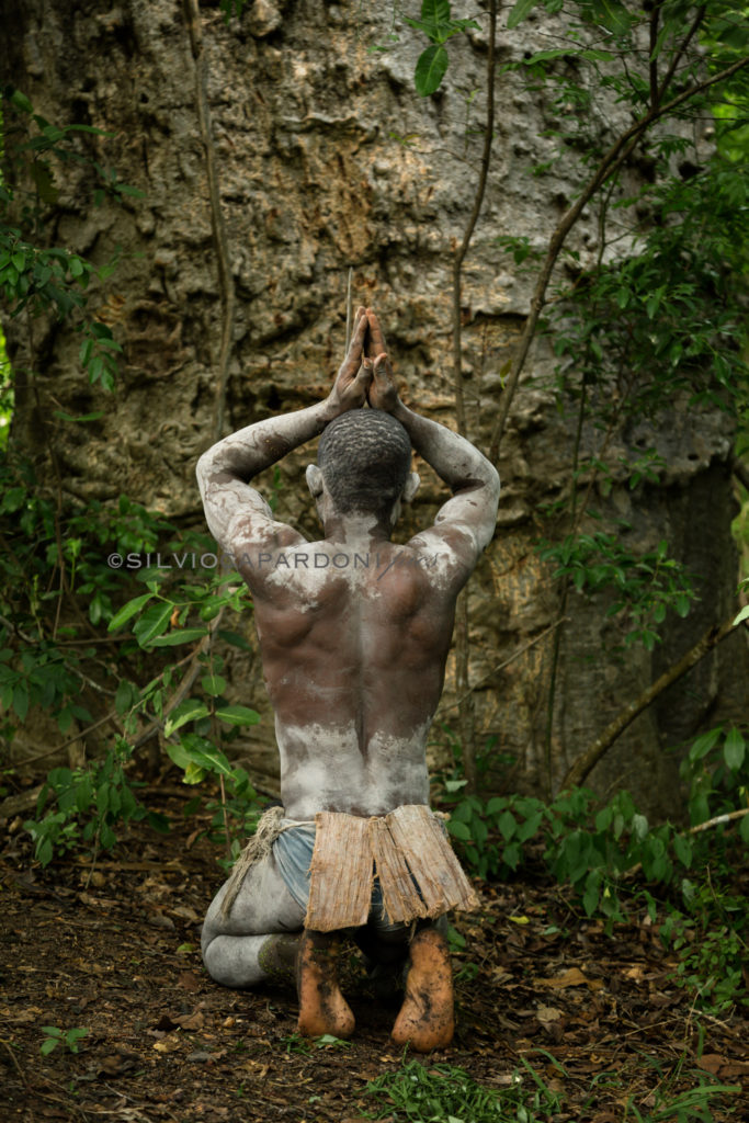 Man who worships a big baobab the tree of life for its religion, Selous, Tanzania