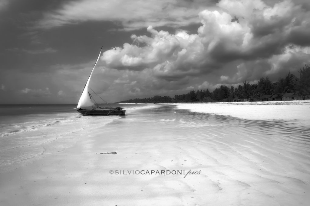 African boat on the shoreline of the beach is ready to go, Zanzibar, Tanzania